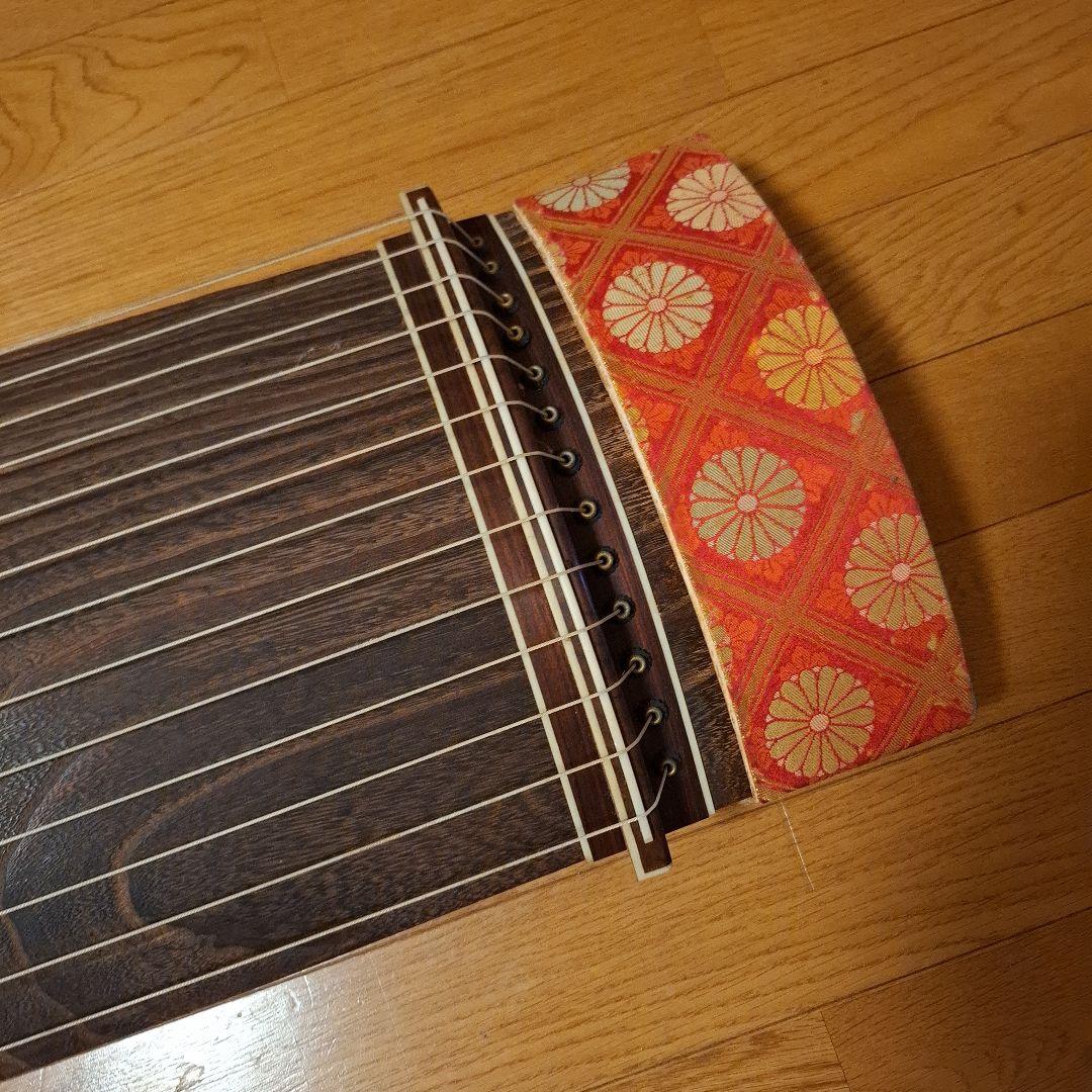 オレンジ色の鶴模様の袋つき　　　お琴